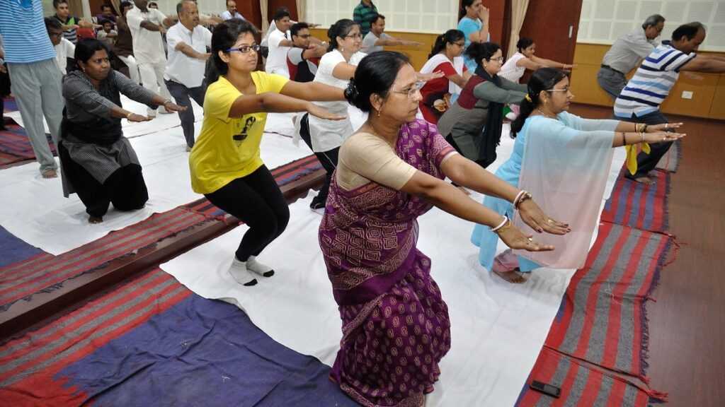 Groupe pratiquant une mobilisation douce des genoux en contexte yoga après une entorse